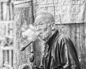 Old Zhuang Chinese man smoking