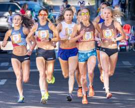 Group of 7 elite female runners racing in a mile road race in Flagstaff Arizona