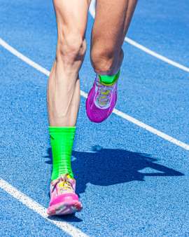 Legs and feet of female track athlete