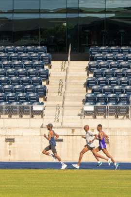 Group of three African professional runners training on a high altitude track at Northern Arizona University.