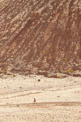Solo male running along the base of SP Crater volcano in northern Arizona