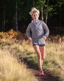 Fit blonde harired woman running on the Arizona Trail near Flagstaff Arizona