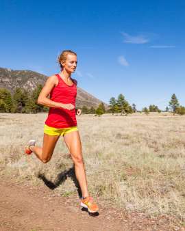 Fit woman runner trail running in Buffalo Park Flagstaff Arizona